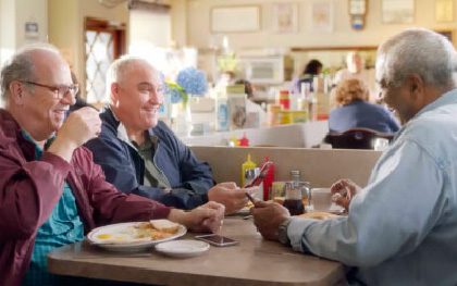 Seniors laughing over breakfast conversation