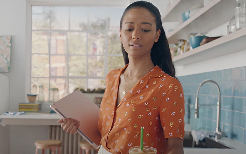 Woman in orange blouse with tablet