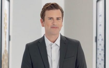 Man in suit smiling confidently