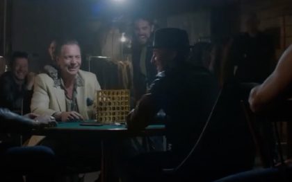 Group enjoying poker game at night.
